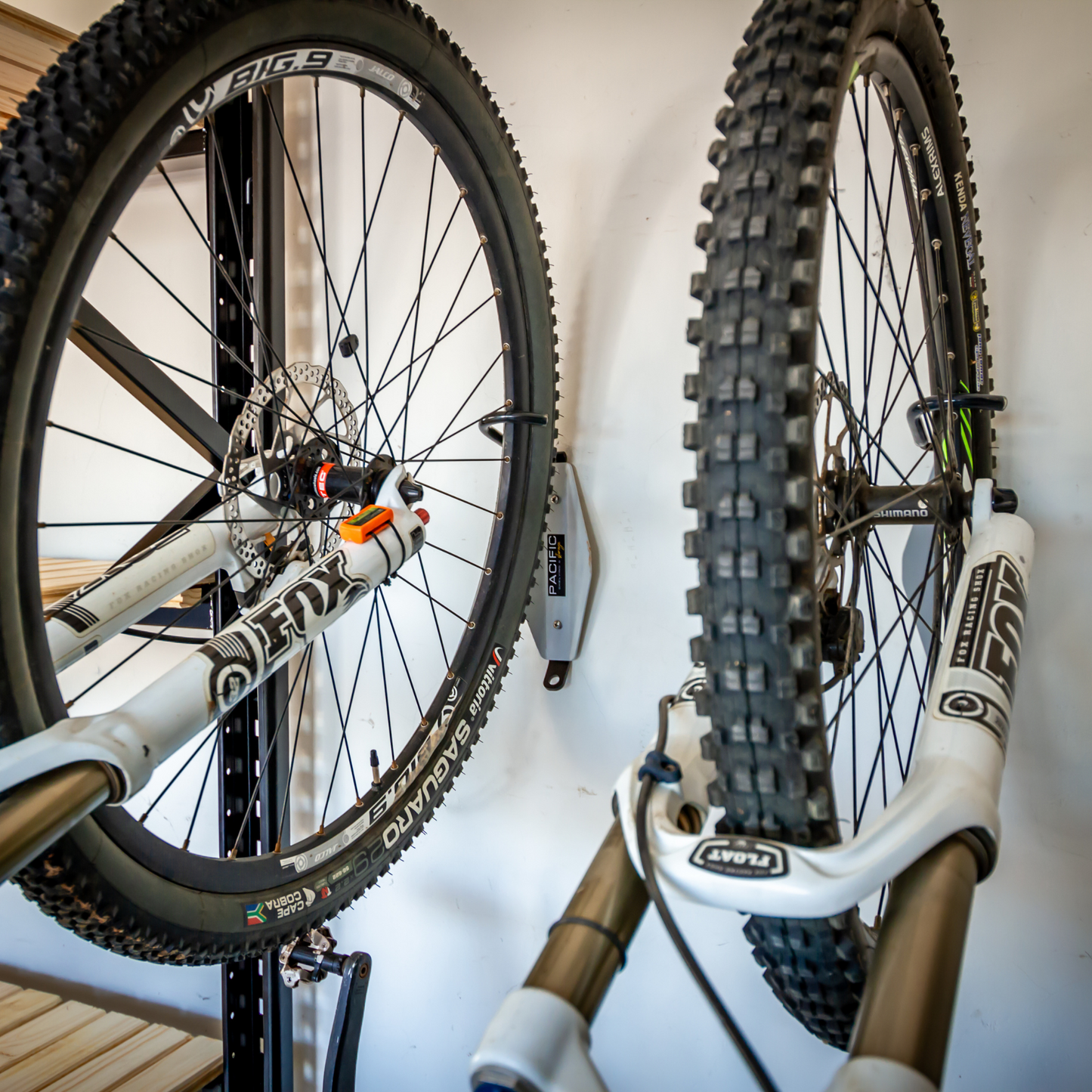 Two bicycles mounted on wall brackets